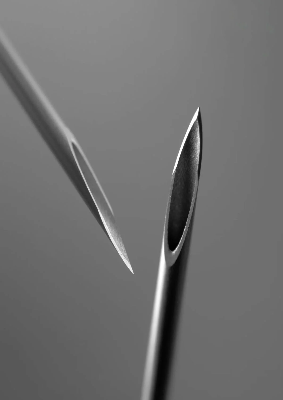 Close-up view of two hypodermic needle tips